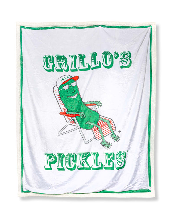 blanket with "grillo's pickles" and pickle in lawn chair on it